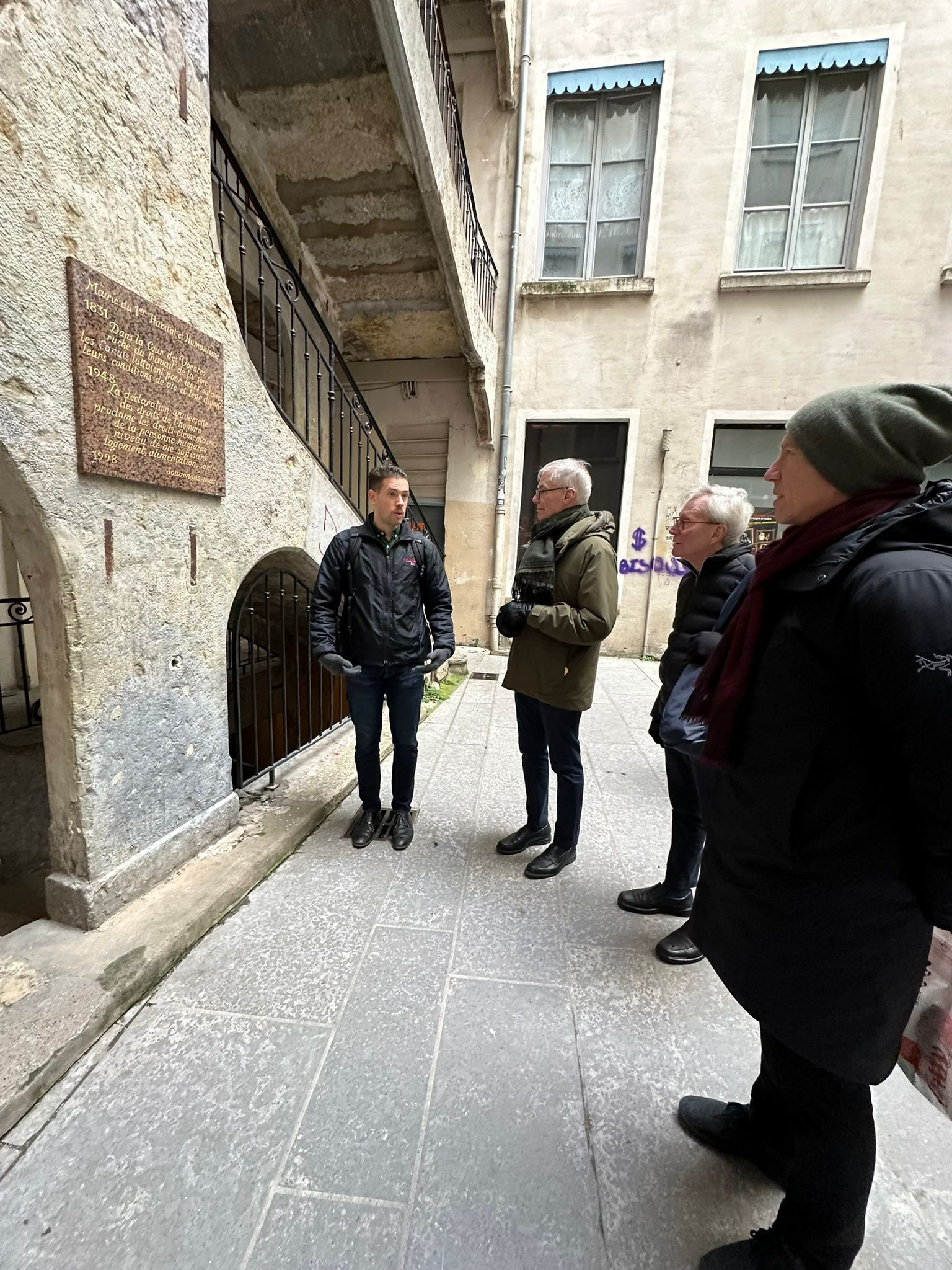 Matt explaining history to tour guests inside a Lyon traboule